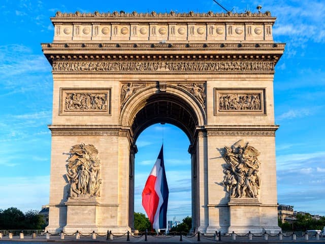 Early in the morning the french flag is installed on the arc de triomphe for the bastille day parade