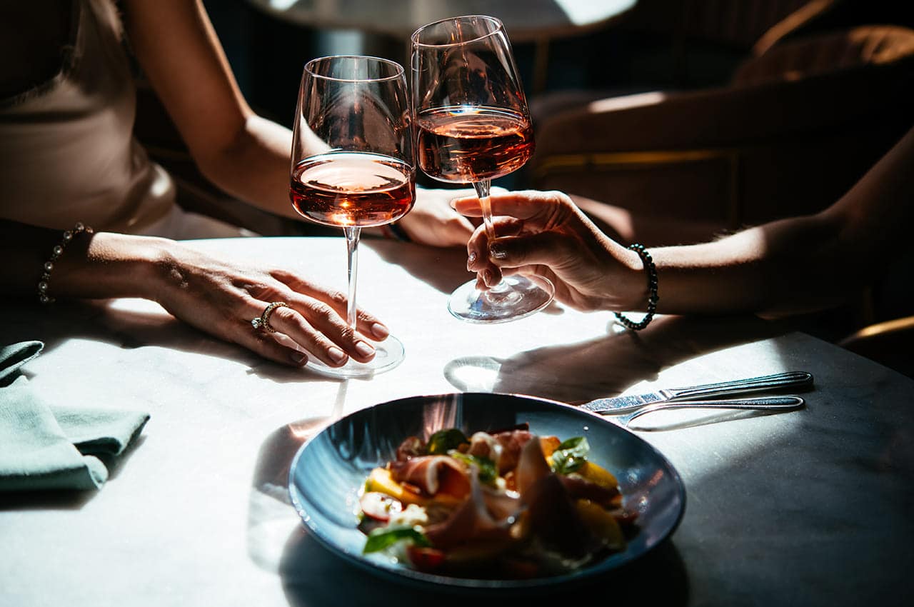 Glasses of rose wine seen during a friendly party or a celebration in a restaurant of a bar