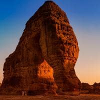 Elephant rock natural geological formation with unidentified tourists at the base looking up alula w