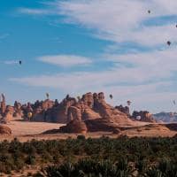 Winter at tantora hot air balloon festival over mada saleh ancient site saudi arabia