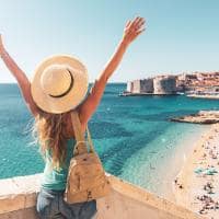 Happy woman tourist enjoying view of the old town of dubrovnik in croatia