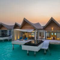 Kuredhivaru resort and spa overwater pool villa exterior sunset