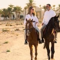 Anantara sahara tozeur resort couple horses resort in background