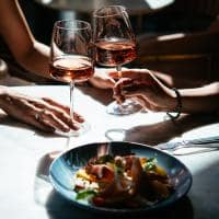 Glasses of rose wine seen during a friendly party or a celebration in a restaurant of a bar
